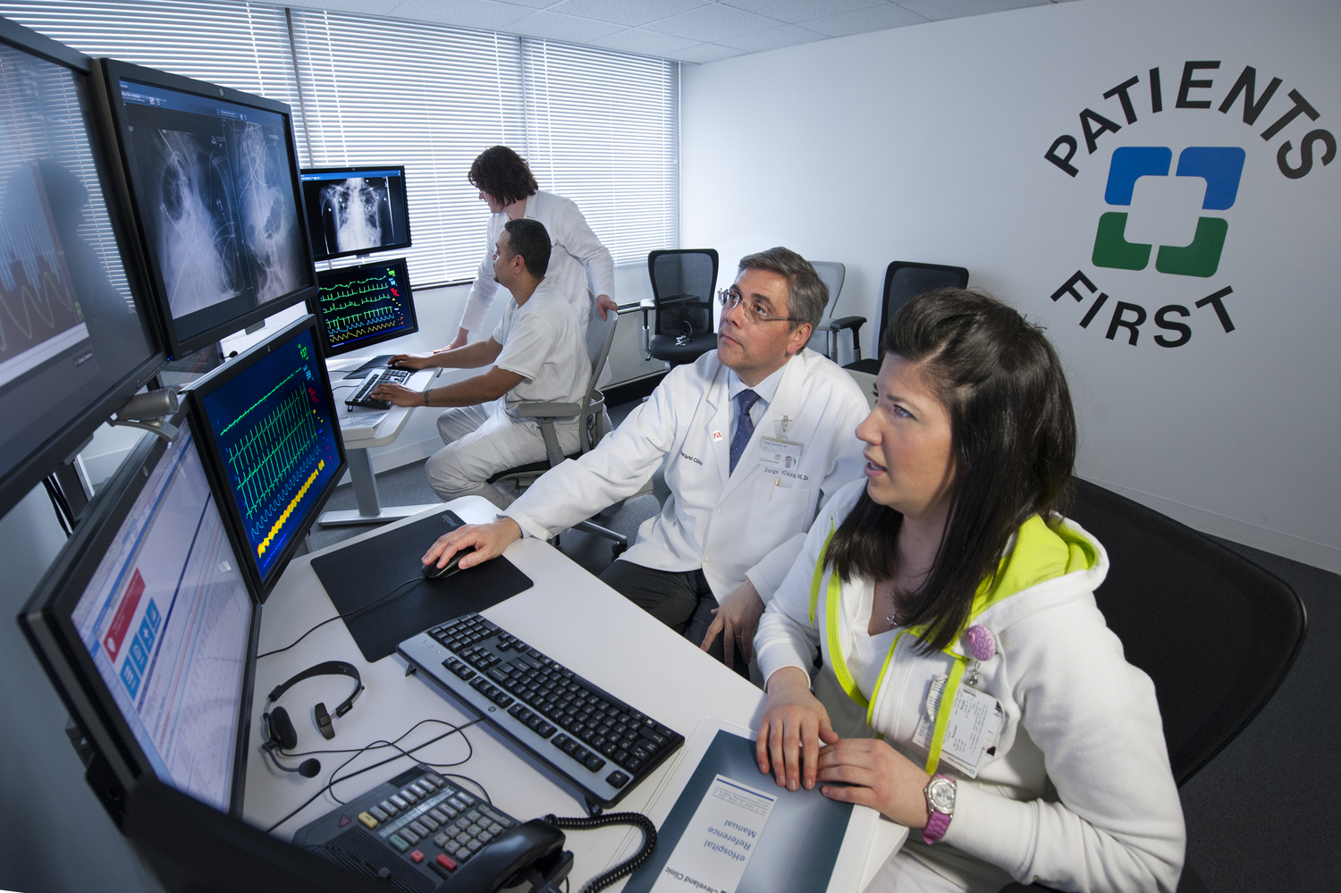 Image of two people working on a computer 