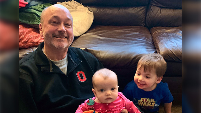 Image of Mark with his two grandchildren